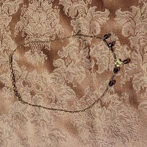1928 dainty gold necklace with purple beads.